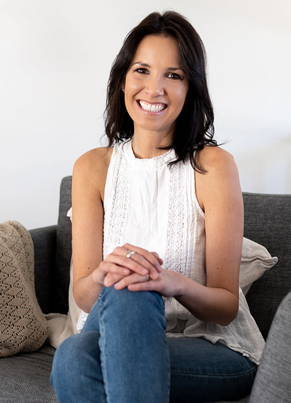 A portrait of Julie Stamm sitting and smiling