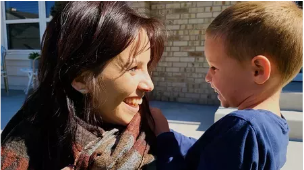 Julie smiling and looking at her son, Jack