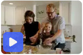 Julie baking with her partner and son in the kitche